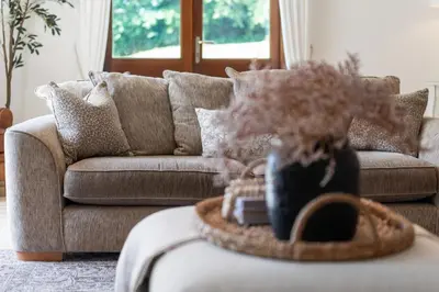 a living room with a couch and a table at Swift Barn Lambest Farm Menheniot Cornwall in Menheniot
