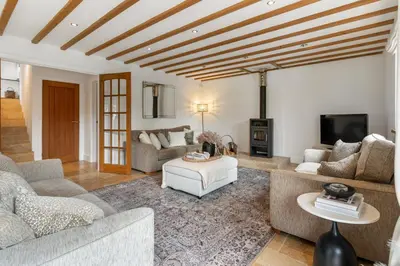 a living room with couches and a tv at Swift Barn Lambest Farm Menheniot Cornwall in Menheniot