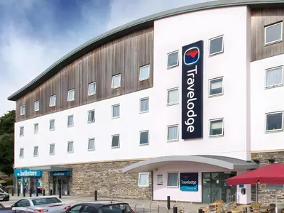 a large white building with a sign on it at Travelodge St Austell in St Austell