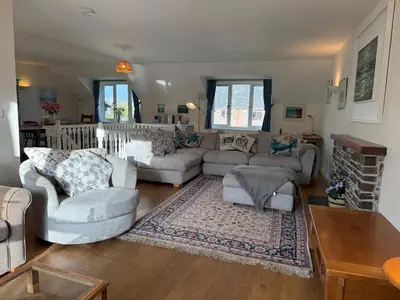 a living room with a couch and chairs and a table at Caldarvan in Wadebridge