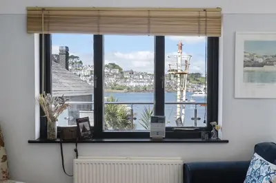 a window in a room with a view of a harbor at Beautiful Cottage on the Water Front Polruan in Polruan