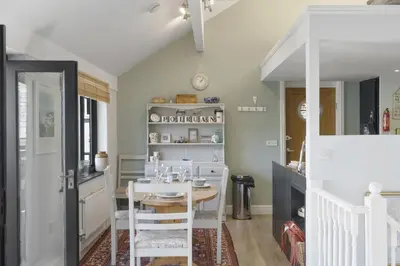 a kitchen with a table and chairs in a room at Beautiful Cottage on the Water Front Polruan in Polruan