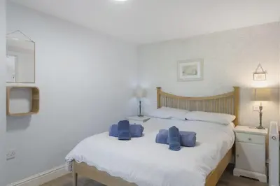 a bedroom with a bed with blue towels on it at Beautiful Cottage on the Water Front Polruan in Polruan