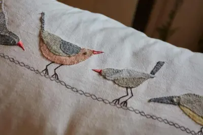 three birds on a blanket on a bed at The Old Post Office Private Parking & Garden in Newquay