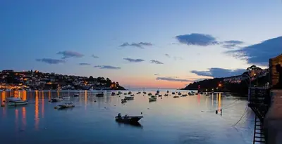 a group of boats in a body of water at Sundance Cottage Central Fowey with Sea Views in Fowey