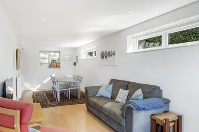 a living room with a couch and a table at Spacious Apartment in Rock Private Parking in Roche