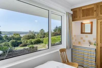 a bedroom with a large window with a view at Spacious Apartment in Rock Private Parking in Roche