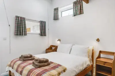 a bedroom with a bed with two towels on it at Spacious Apartment in Rock Private Parking in Roche