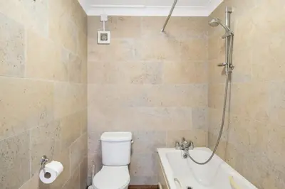 a bathroom with a toilet and a tub and a shower at Spacious Apartment in Rock Private Parking in Roche