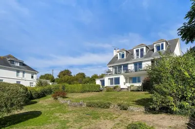 a large white house with a yard at Spacious Apartment in Rock Private Parking in Roche