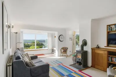 a living room with a couch and a television at Spacious Apartment in Rock Private Parking in Roche