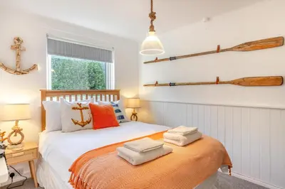 a bedroom with a bed with two oars on the wall at 2 Bed in Carbis Bay oc-h34810 in Carbis Bay