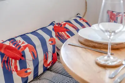 a table with a plate and a glass of wine at 2 Bed in Carbis Bay oc-h34810 in Carbis Bay