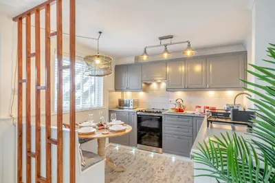 a kitchen with gray cabinets and a wooden table at 2 Bed in Carbis Bay oc-h34810 in Carbis Bay