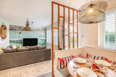 a living room with a table and a couch at 2 Bed in Carbis Bay oc-h34810 in Carbis Bay