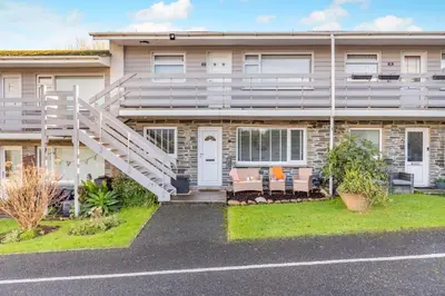 an apartment building with a staircase in front of it at 2 Bed in Carbis Bay oc-h34810 in Carbis Bay
