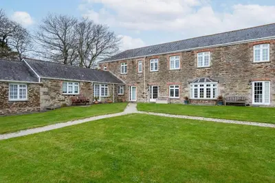 a large brick building with a large yard at 2 Bedroom Cottage Close to Perranporth Beach in Roche