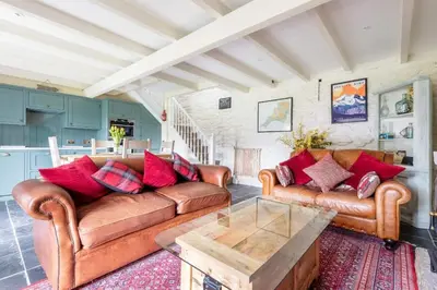 a living room with two couches and a coffee table at 2 Bedroom Cottage Close to Perranporth Beach in Roche