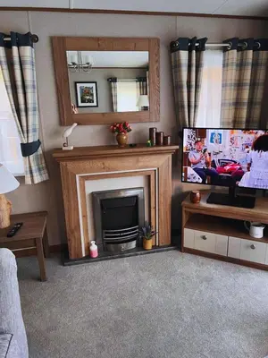 a living room with a fireplace and a television at St Minver Hideaway in Saint Minver