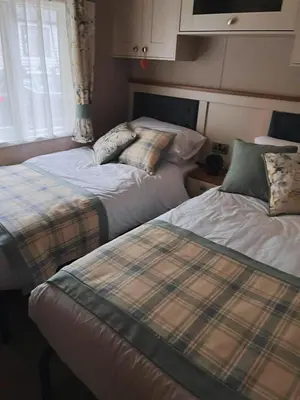 two beds sitting next to each other in a room at St Minver Hideaway in Saint Minver