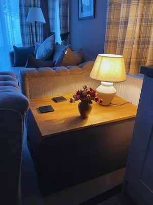 a living room with a table with a lamp on it at St Minver Hideaway in Saint Minver