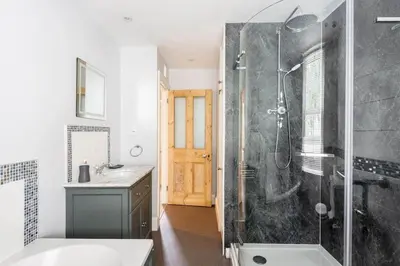 a bathroom with a shower and a sink at Gin O'Clock Mevagissey Level Walk to Harbour in Mevagissey