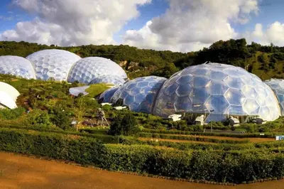 a bunch of domes in a garden with trees at Gin O'Clock Mevagissey Level Walk to Harbour in Mevagissey
