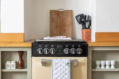 a stove top oven in a kitchen with utensils at Gin O'Clock Mevagissey Level Walk to Harbour in Mevagissey