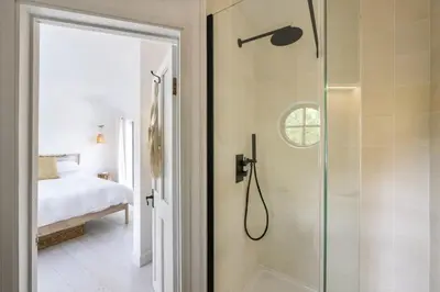 a bathroom with a shower with a glass door at Beautiful Home in Heart of Truro in Truro