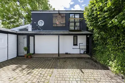 a blue and white house with a patio at Beautiful Home in Heart of Truro in Truro