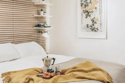 a bed with a blanket and a blender on it at Romantic Converted Barn Perfect St Agnes Location in St. Agnes