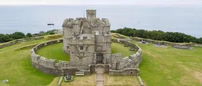 an old castle sitting on top of a grass field at Bright Flat with Estuary Views & Parking Falmouth in Falmouth