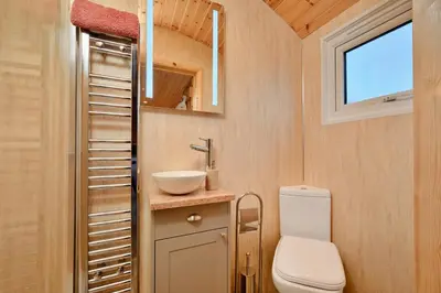 a small bathroom with a toilet and a sink at Finest Retreats - Demelza Shepherds Hut in Grade