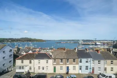 a view of a city with houses and a harbor at Penthouse Apartment with Sea Views Falmouth in Falmouth