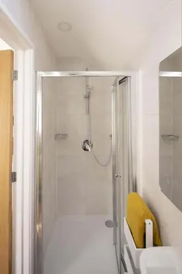 a bathroom with a shower with a sink and a toilet at Cottage & Boatshed in Gorran Haven Private Parking in Gorran Haven
