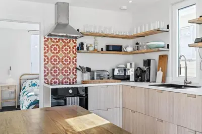 a kitchen with a sink and a stove top oven at Beach House with Stunning Sea Views in Portreath