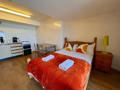 a bedroom with a bed with two towels on it at Retro Ocean View Pad by Fistral Beach in Newquay