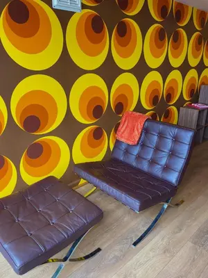 a room with a couch and a colorful wall at Retro Ocean View Pad by Fistral Beach in Newquay