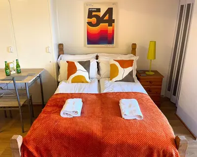 a bedroom with a large bed with two towels on it at Retro Ocean View Pad by Fistral Beach in Newquay