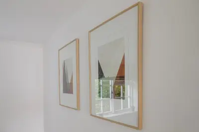 two framed pictures on a wall at Old Cottage 1 min from the sea! Crackington Haven in Crackington Haven
