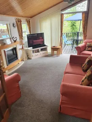 a living room with a flat screen tv and a couch at The Retreat in Polperro