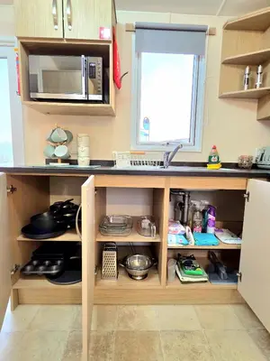 a kitchen with a counter with a sink and a microwave at The Crab Shack in Tywardreath