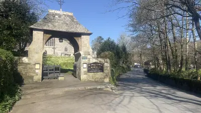 a gate to a building with a sign on it at Chapel Cottage St Mawgan on the Cornish coastline in Saint Mawgan