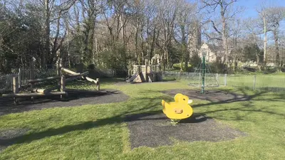 a playground with a yellow duck toy in the grass at Chapel Cottage St Mawgan on the Cornish coastline in Saint Mawgan