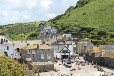 a town with a bunch of buildings and a hill at Harbour Loft Port Isaac harbour beach views in Port Isaac
