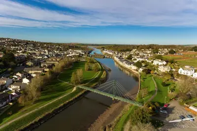 an aerial view of a town with a river at Hay Barn St Breock beautiful countryside views in Wadebridge