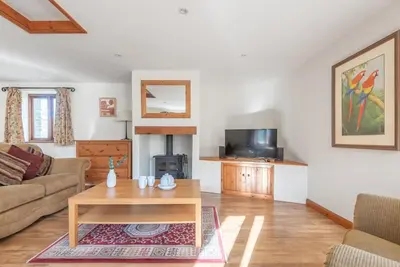 a living room with a couch and a coffee table at Hay Barn St Breock beautiful countryside views in Wadebridge