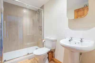 a bathroom with a toilet and a sink and a shower at Hay Barn St Breock beautiful countryside views in Wadebridge