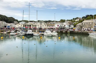 a group of boats are docked in a harbor at Fernleigh Cottage near the North Cornish beaches in Saint Mabyn