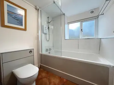 a bathroom with a tub and a toilet and a shower at Fernleigh Cottage near the North Cornish beaches in Saint Mabyn